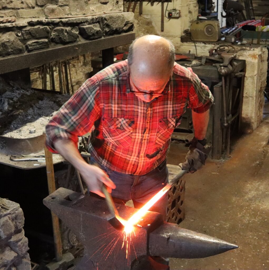 Paul at the anvil making a taper